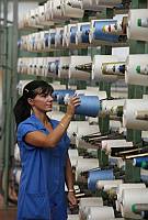 Lonate Pozzolo (Va) Filatura Michele Solbiati , 7 operaie dell'azienda posano per servizio di moda per Donna Moderna,riprese in fabbrica in una giornata di lavoro.<br>nella foto:Annamaria Casubolo (capelli lisci) foto Gianluca Moggi/Massimo Sestini